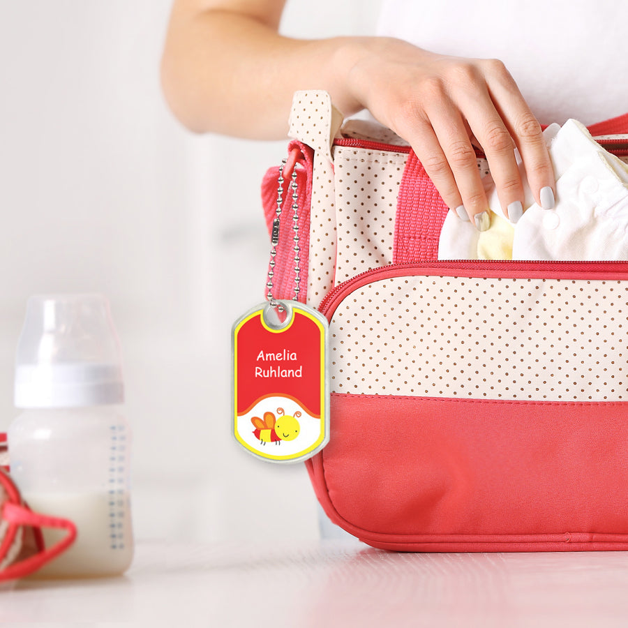 Customized name tag chained to a diaper bag