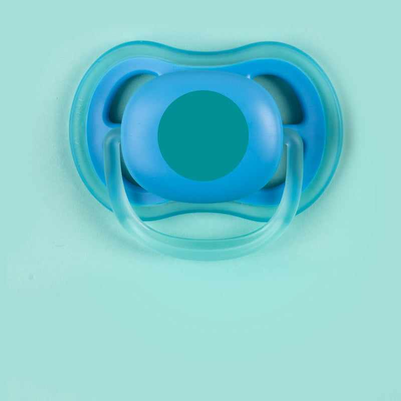 Teal design mini round stick on name label applied to a pacifier
